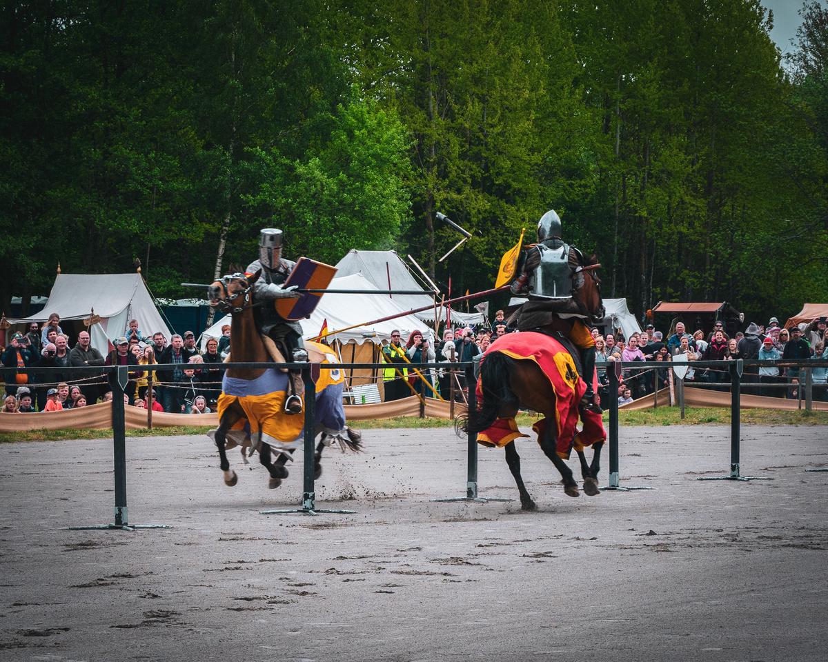 A medieval knight riding a horse in a jousting tournament